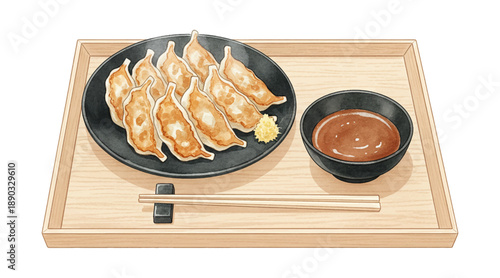 Delicious pan fried gyoza dumplings with dipping sauce and chopsticks served on a wooden tray
