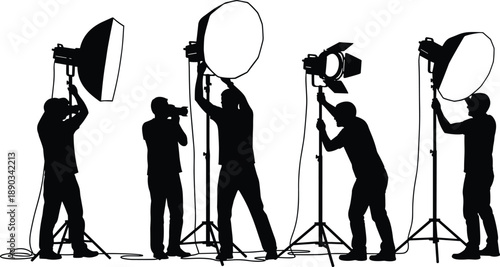 Photography studio crew silhouettes adjusting professional lighting equipment and softboxes during creative photoshoot setup representing teamwork, production workflow