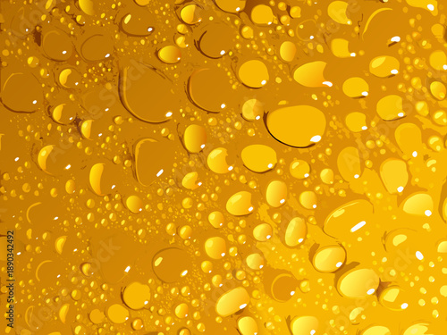 Close up of golden liquid with numerous water droplets on its surface