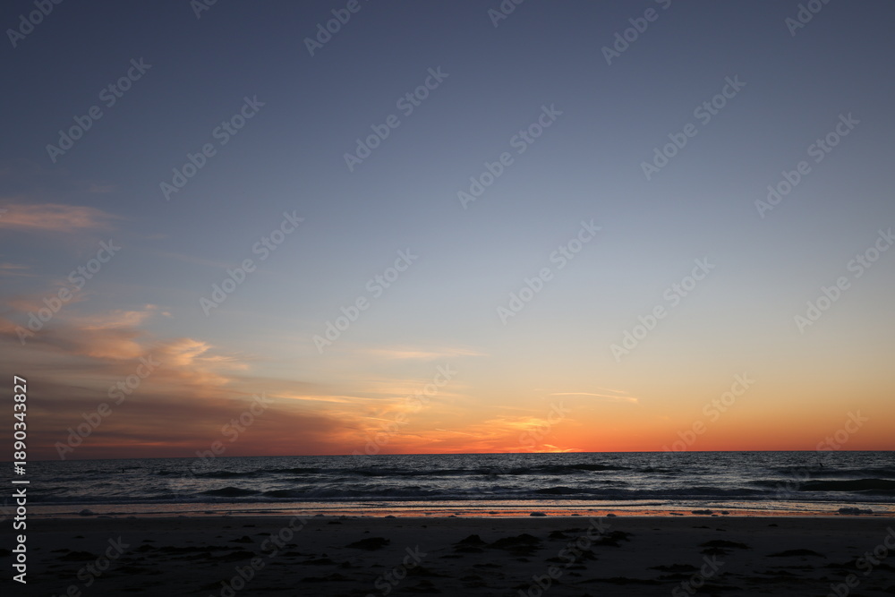 Fototapeta premium All about the peacefulness and the darkening colors of the sky over the ocean at sunset in Florida. 