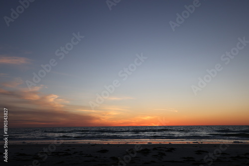 All about the peacefulness and the darkening colors of the sky over the ocean at sunset in Florida. 
