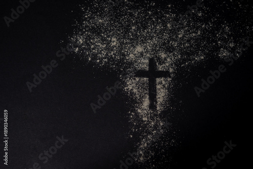 Slika na platnu A cross shape formed in scattered ashes on a dark textured background represents the symbolic meaning of Ash Wednesday and repentance