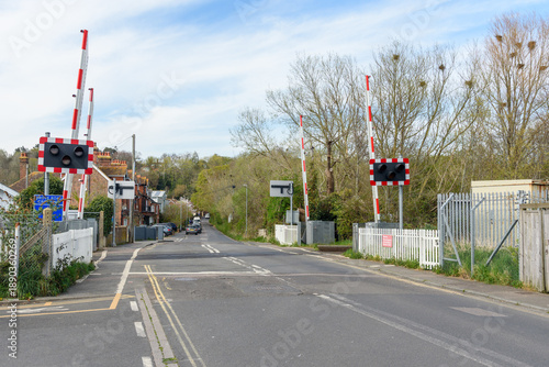 Valokuva Level crossing with signals along a road running through a small town in the cou