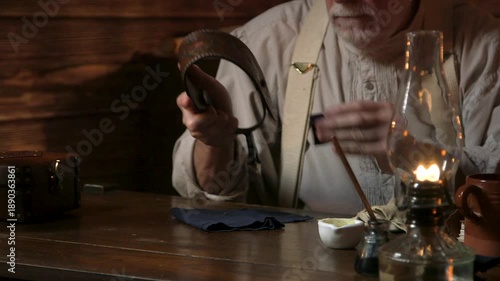 1890s cowboy cleaning his spurs