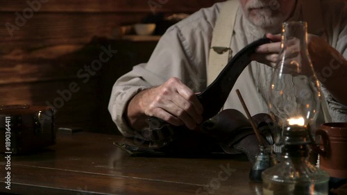 old west cowboy working on his gun belt and holster