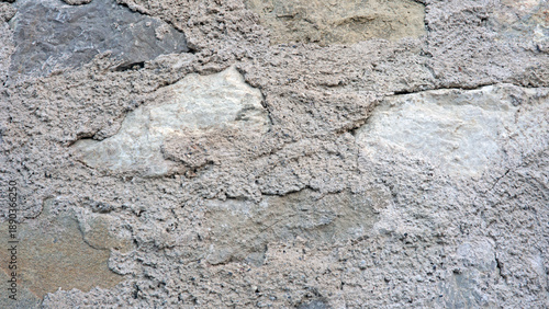 Italian Stone wall, garda lake with cement and rough texture in a building site during daylight hours suitable for rendering