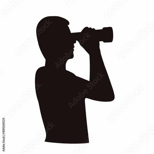 Silhouette of a man using binoculars, looking towards the future direction