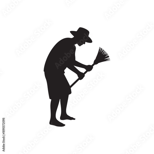 Man in a hat sweeping with a broom silhouette