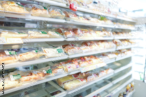 Shelves with a variety of packaged breads in a store. Blurred.