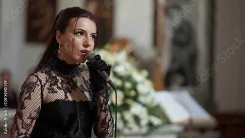 Female Singer Performing Requiem at Funeral Service in Church
