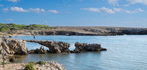 The quiet bay named Cala Rotonda, with a natural arch and unique sunsets on the isle of Favignana, Trapani province, Sicily, Italy.