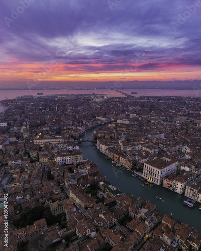 Wallpaper Mural Aerial view of the Grand Canal snaking through the terracotta rooftops, reflecting the vivid sunset hues painting the Venetian sky, Venice, Veneto, Italy. Torontodigital.ca