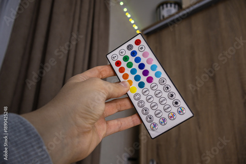 Hand holding RGB LED light remote control