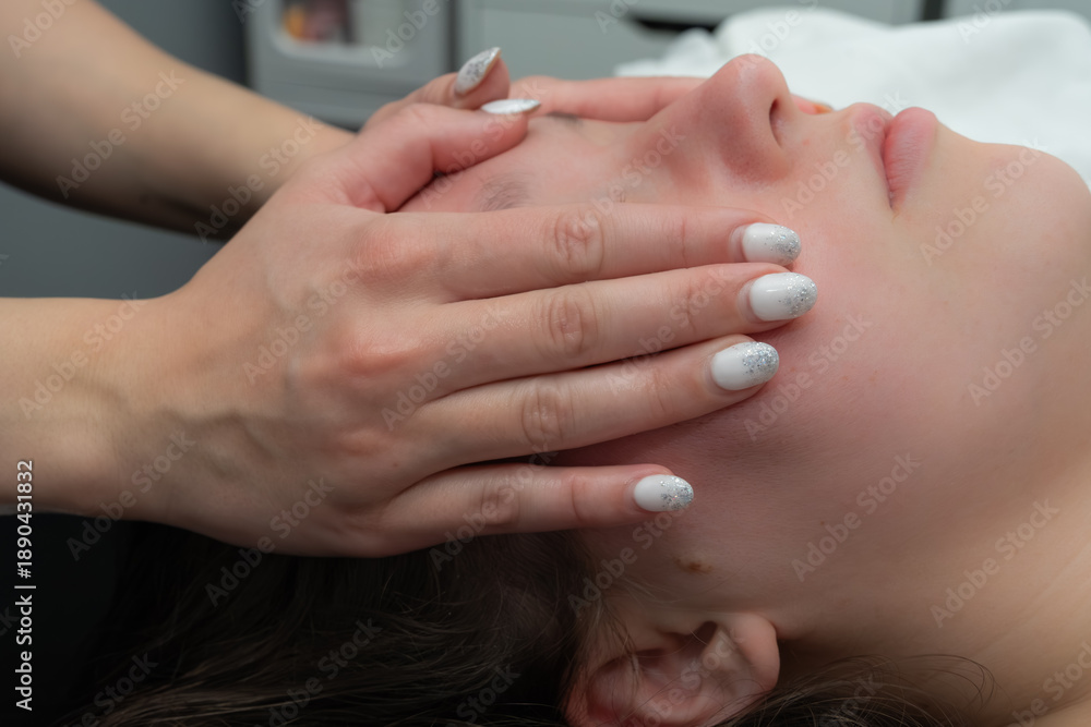 Fototapeta premium Woman getting a massage at a spa from massage therapist