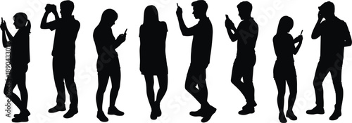 Silhouettes of people using smartphones while standing, modern digital lifestyle showing mobile communication, social media interaction and technology dependence concept