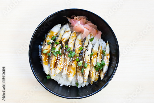 Pickled mackerel or Shime Saba donburi rice bowl with fresh slices, pickled ginger, and green onions. Traditional Japanese seafood meal, top view.