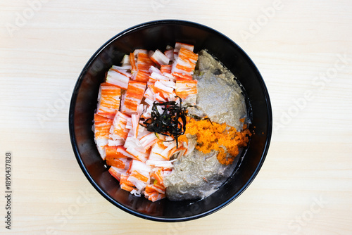 Japanese Kani Miso Donburi featuring rich crab paste, imitation crab sticks (kani), and shrimp roe on rice, topped with shredded nori. Top view close-up.