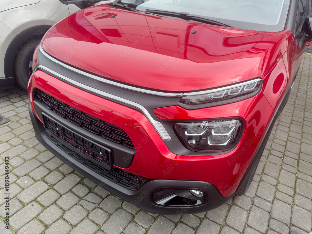 Naklejka premium red luxury new crossover car in auto salon. Expensive purchase for every one