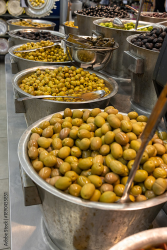 Green Olives with Chili Peppers at Mediterranean Market Counter