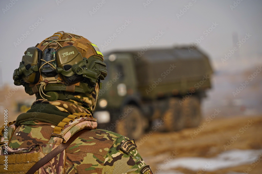 Fototapeta premium Almaty, Kazakhstan - 01.20.2026 : A soldier in full uniform at a military exercise.
