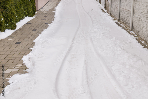 Snow in the house driveway in the end of the winter. Snow melting