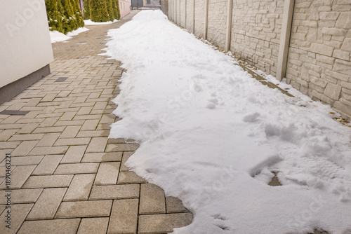 Snow in the house driveway in the end of the winter. Snow melting