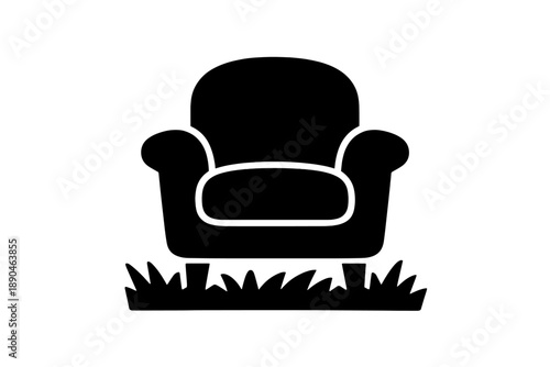 Comfortable upholstered armchair placed outdoors on a small patch of grass