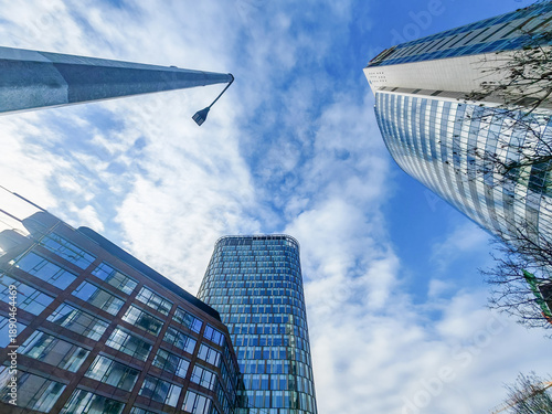 Tall buildings in the city. Skyscrapers under a blue sky. Led lamp