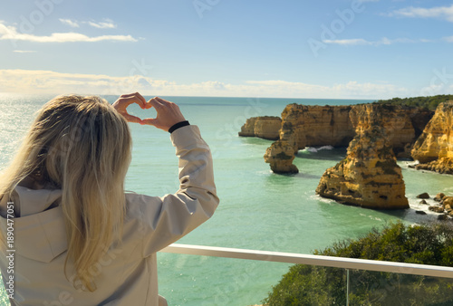 Praia da Marinha, beautiful beach Marinha in Algarve, Portugal. Navy Beach (Praia da Marinha) with flying seagulls over the beach, located on the Atlantic coast in Lagoa Municipality, Algarve.