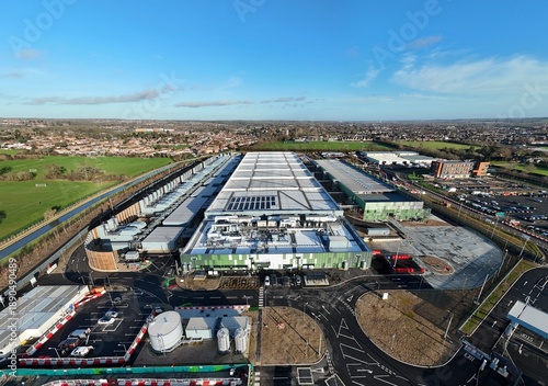 Aerial view of the sprawling Google AI data centre complex, a modern industrial landscape contrasting against the surrounding greenery, Waltham Cross, United Kingdom.