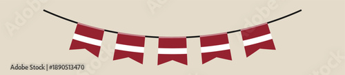 Garland of Latvian flag bunting pennants hanging on a string for a festive national holiday or patriotic celebration.