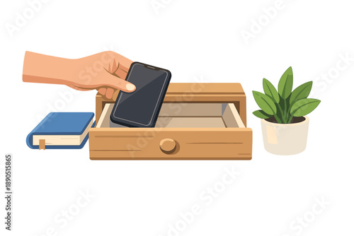 Hand places smartphone into open wooden drawer near a blue book and a small green plant on a white background