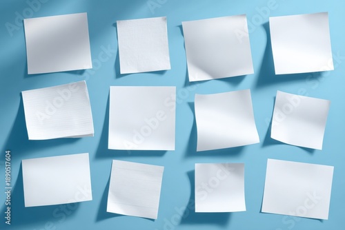 Wallpaper Mural Blank white paper sheets arranged on blue surface in various angles and sizes Torontodigital.ca