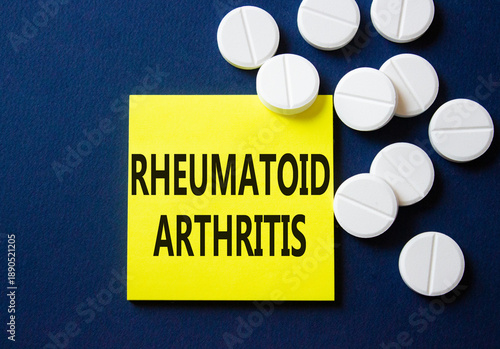 Rheumatoid Arthritis symbol. Concept word Rheumatoid Arthritis on yellow note. Beautiful deep blue background with pills. Medicine and Rheumatoid Arthritis concept. Copy space