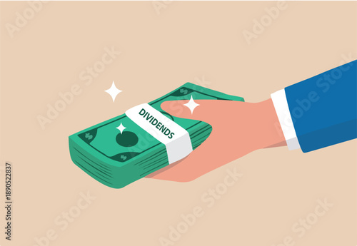 Dividends stock payment, passive income from dividend yield concept, rich and wealthy businessman hand holding pile of dollar money banknotes with the word Dividends.