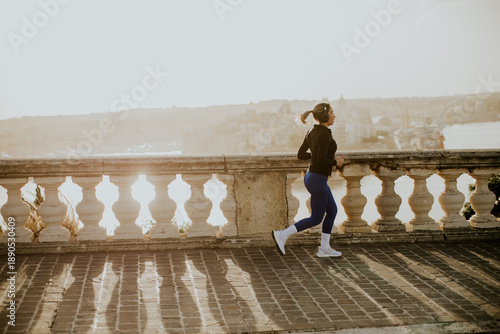 Woman jogs along the coast ...