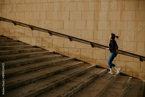 Woman exercises on steps in...