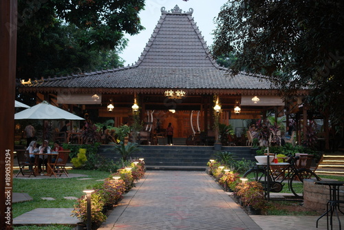Traditional Balinese restaurant with outdoor seating area at dusk