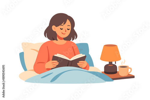 Young woman reads a book in bed during the morning with a cup of coffee on a table and a lamp providing light in a cozy setting