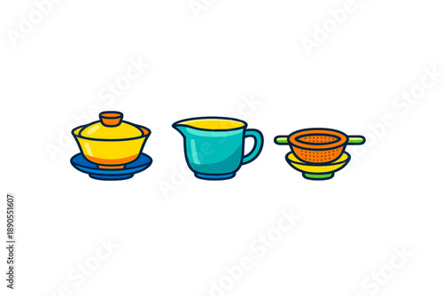 Colorful tea set with a teapot, creamer, and strainer arranged on a table in a kitchen during day