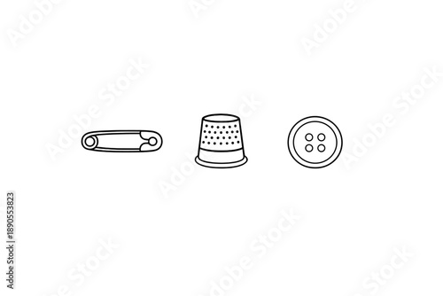 Different sewing tools are arranged in a line showing a safety pin, a thimble, and a button, offering a simple view of items used in sewing