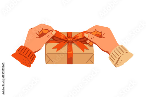 Hands are unwrapping a present with a ribbon in a cozy indoor setting during a festive occasion