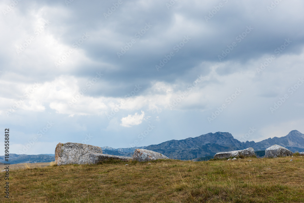 Fototapeta premium Wide hillside scene featuring ancient tombstones