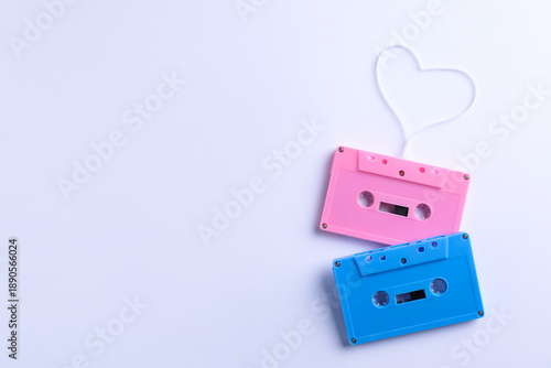 Music cassettes and heart made with tape on white background, top view. Space for text