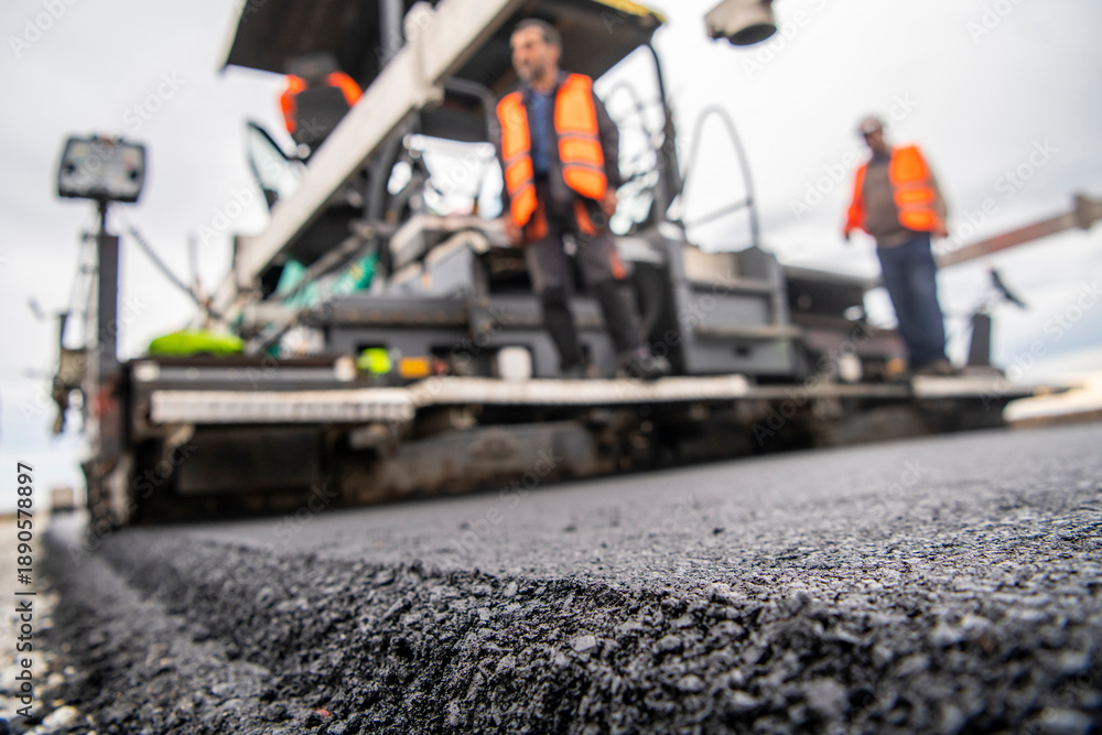 Fototapeta premium Road construction and asphalt paving and leveling machines.