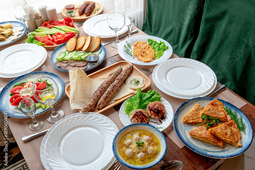 Valokuva Large spread of traditional dishes on a table during a gathering in a cozy space