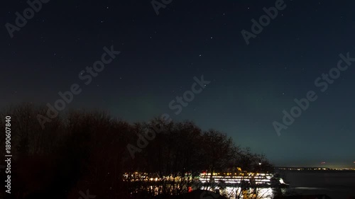 Ferry dock at night in the pacific northwest with northern lights in the sky