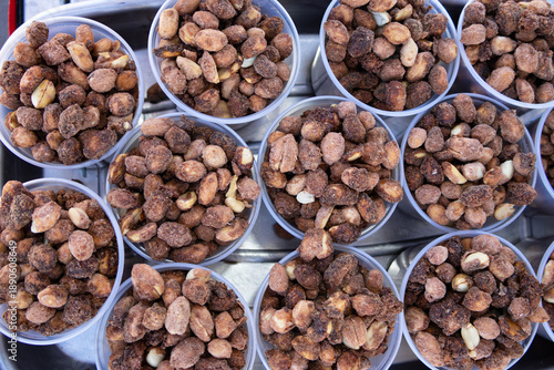 Tray with small cups containing roasted peanuts covered in caramelized sugar - top view