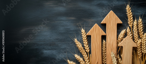 Upward wooden arrows with golden wheat on dark background with space for text. Business growth, agriculture, grain market concepts