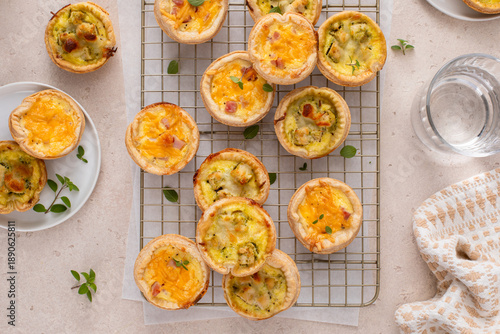 Mini quiches with ham and cheese and chicken and pesto, healthy breakfast or snack idea © fahrwasser